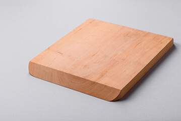 Empty wooden cutting board on gray textured concrete background