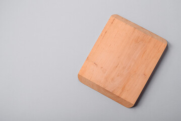 Empty wooden cutting board on gray textured concrete background