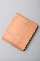 Empty wooden cutting board on gray textured concrete background