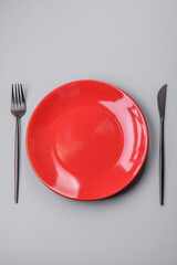 An empty plate on a gray concrete background with copy space