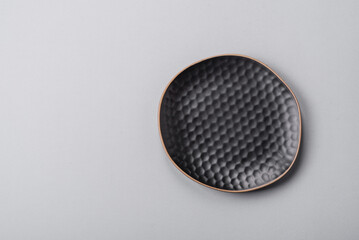 An empty plate on a gray concrete background with copy space