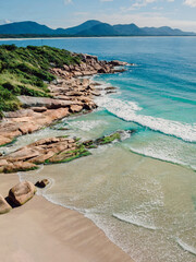 Beach with rocks and blue ocean in Brazil. Aerial view of tropical beach in Florianopolis - 787411827