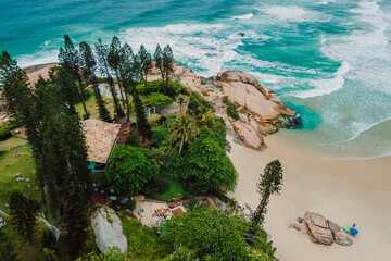 Joaquina beach with evergreen trees and ocean with waves in Florianopolis, Brazil. Aerial view - 787411832