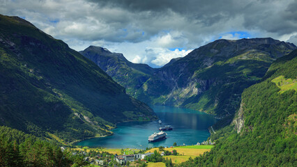 Panoramic view on cruise ships stand in the harbor of the Geiranger fjord, Norway	