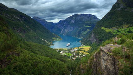 Panoramic view on cruise ships stand in the harbor of the Geiranger fjord, Norway	