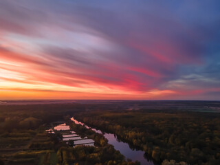 Aerial view of beautiful river and forest landscape with colorful summer sky