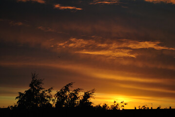 Clouds and Dark Silhouettes of Colourful Scottish Sunset 