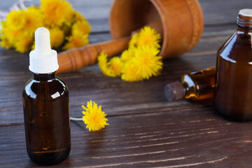 Flower and dandelion extract. Medicinal wild plants and medicinal tincture from it. Bottles of...