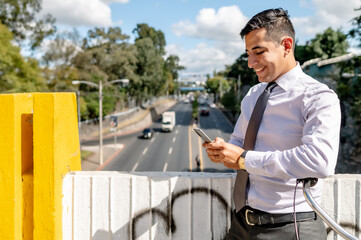 Businessman with smartphone in his hands, texting.