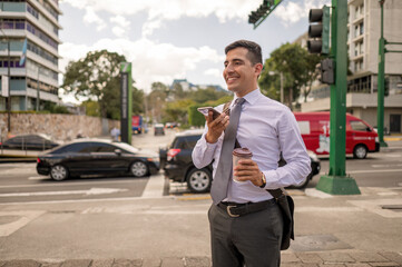 A latin man in a suit talking on cell phone in the streets of Guatemala City.