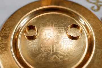 wedding rings on a gold plate