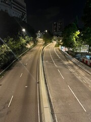 This is dark and empty, with no cars or people on the road.
which are all silhouetted against the sky. It is a peaceful and serene scene.
