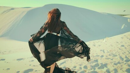 happy beauty woman dancing in desert white sand sun light sky. Long black silk dress hair flying fluttering in wind slow motion. Cheerful tourist enjoying vacation in Dubai desert. Video footage 4K - Powered by Adobe