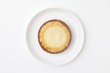 Sweet pie with sour cream at a round plate isolated at white background. Pastry image.
