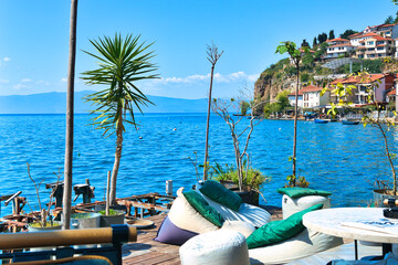 Lake Ohrid, North Macedonia, April 13 2024. Mountain range and peninsula in distance. Ohrid Lake, Macedonia, Europe. The clear mesmerizing waters of lake Ohrid with a beautiful view.  - obrazy, fototapety, plakaty