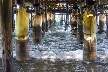 The Resort Pier at San Diego, California, looking under the Pier at the Ocean and Pilings