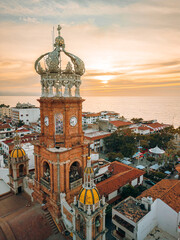 Close up aerial view of our Lady of Guadalupe church in Puerto Vallarta, Mexico with sun setting.