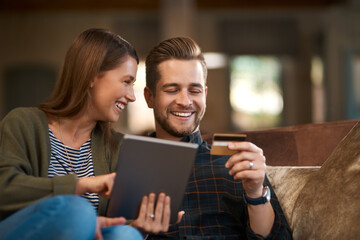 Bank, card and couple with tablet for credit score, loan or mortgage, payment and application on sofa at home. Ecommerce, online shopping and happy people with digital, search or sig up subscription