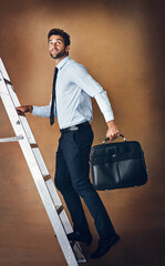 Businessman, climbing and corporate ladder in studio for work opportunity, promotion and high...