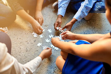 Diversity, group and puzzle on floor with teamwork, support and solution for problem. Partnership,...