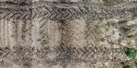 view from above on texture of wet muddy road with tractor tire tracks in countryside - 787461628