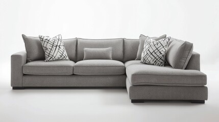 A gray sectional sofa with white pillows and a black and white pattern