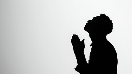 Silhouette of a men praying with copy space - obrazy, fototapety, plakaty