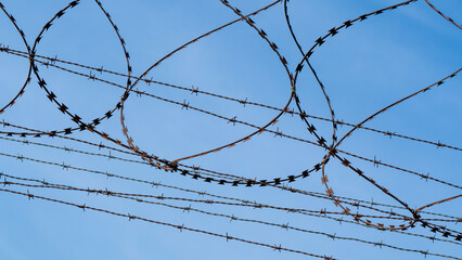 Barbed wire over a metal fence