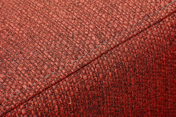 Textured red furniture fabric with stitching