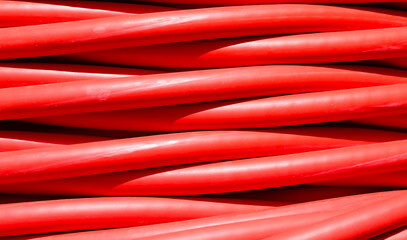 thick red electrical cable used for high-voltage power transmission from a power plant to...