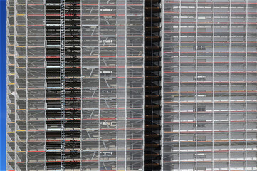 detail of scaffolding of the façade of a skyscraper during maintenance to install the thermal insulation for energy saving
