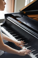 Woman, musician and playing with piano for music, melody or sound with acoustic instrument at home....