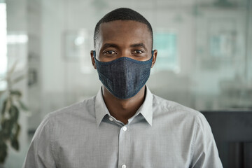 african businessman wearing a protective face mask in an office