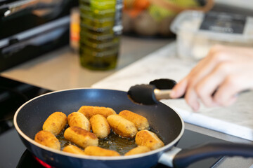 cooking and frying croquettes in olive oil
