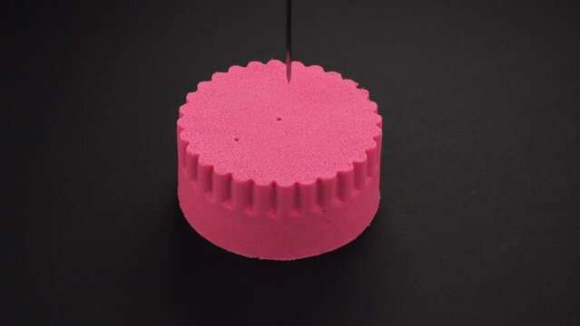 Very Satisfying and Relaxing Kinetic Sand ASMR. Cutting anti stress macro close up colorful Kinetic Sand with a Knife. Kinetic sand cutting with a knife on a black background. ASMR .