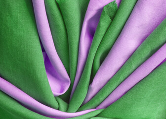 Green and pink draped linen fabric. Woven  texture background. Various colors textile drapery for...