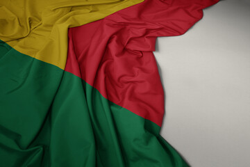 colorful national flag of benin on a gray background.