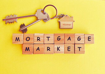 Wooden cubes with the word mortgage market and keys