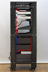 A telecommunications rack with Ethernet switches for connecting to the Internet. Audio amplifiers with audio system connection terminals are installed.