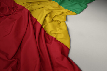 waving national flag of guinea on a gray background.