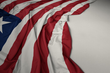 waving national flag of liberia on a gray background.