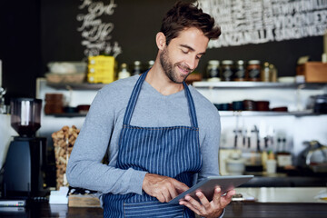 Small business, cafe and man with tablet checking review, online booking or reservation in coffee...