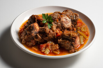 Isolated Bowl with a portion of oxtail stewed vaccinara