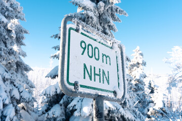 Wegweiser mit Höhenangabe im Harz. Winterzeit mit Frost und Schnee