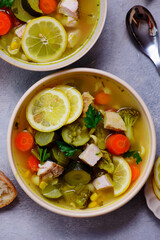 Vegetable soup with baked chicken and lemon .top veiw .style hugge