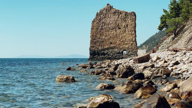 Giant rock, similar to a sail, called "Sail" on the Black Sea coast of the Caucasus Mountains, Gelendzhik, Russia. Tourist attraction and landmark. Picturesque summer landscape. 4K