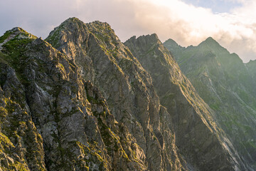 close up view at mountain peaks under clouds. Summer afternoon, Tatra Mountains, Orla Perc - obrazy, fototapety, plakaty