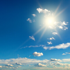 Bright sun on blue sky with beautiful clouds - 787502250