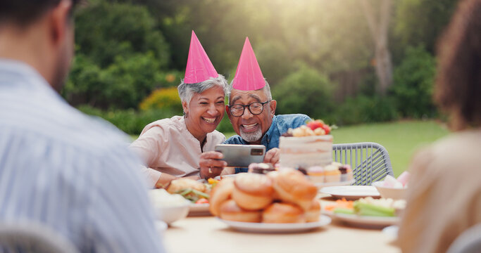 Elderly, couple and happy with video call at birthday party for celebration, laughing and memories in garden. Senior, man and woman with smartphone for photography, gathering and event in backyard
