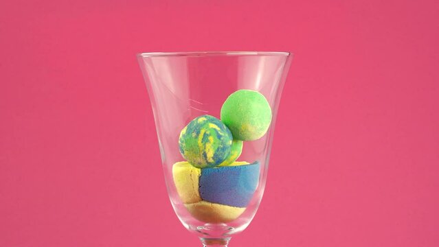 Crush of kinetic sand in a glass on a white background. Very Satisfying and Relaxing Kinetic Sand ASMR video. Cutting anti stress macro close up colorful Kinetic Sand with a Knife. ASMR.